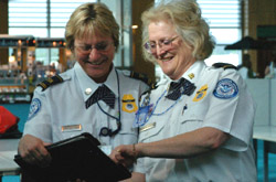 TSA agents looking at clipboard